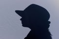 Silhouette of woman wearing a hat, close up. Abstract people concept.