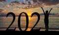 Silhouette of Woman Welcoming New Year 2021 at Beach Sunrise Royalty Free Stock Photo