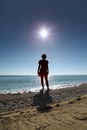 Silhouette of woman which stands on beach in water Royalty Free Stock Photo