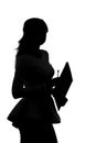 Silhouette of a woman working in an office with a folder for sheets and a pen in the hands Royalty Free Stock Photo
