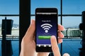 Person`s Hands Using Free WiFi On Smart Phone In Airport