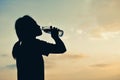 Silhouette women drinking water at sky sunset Royalty Free Stock Photo