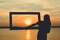 Silhouette of women holding frame