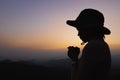 Silhouette of a women is praying to God on the mountain. Praying hands with faith in religion and belief in God on blessing Royalty Free Stock Photo