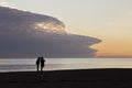 Silhouette of women talking on beach at Brighton