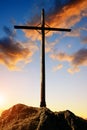 Silhouette wooden cross on the summit of a mountain.