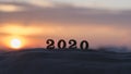 Silhouette of 2020 wooden numbers on the sand on the beach at sunset. Setting sun. The symbol of the outgoing year. 2021.