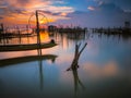 Silhouette wooden posts in lake against sky during sunset Royalty Free Stock Photo