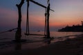 Silhouette wooden swing and calm sea