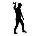 Silhouette of a worker in action pose using his axe tool. Royalty Free Stock Photo