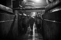 Silhouette of a worker in an industrial room. Monochrome photo.