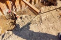 Silhouette of worker with rebar rod installing skeleton of reinforcing steel bars for bridge foundation at construction site Royalty Free Stock Photo