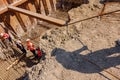 Silhouette of worker with rebar rod installing skeleton of reinforcing steel bars for bridge foundation at construction site Royalty Free Stock Photo