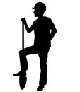 Silhouette of a worker standing with his foot on a shovel