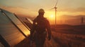 Silhouette of a Worker at Sunrise by Solar Panels and Wind Turbines, Symbolizing Renewable Energy and Eco-Friendly