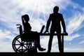 Silhouette worker supports and helps a disabled woman