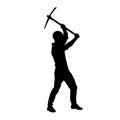 silhouette of a worker swinging his mattock tool.