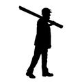 silhouette of a worker walking and shouldering wood boards. Royalty Free Stock Photo