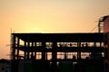 silhouette workers working in construction site at sunset