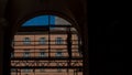 Silhouette of workman standing on scaffold in archway