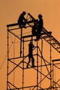 Silhouette of Workmen on assembling concert stage Royalty Free Stock Photo