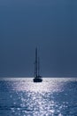 Silhouette of a yacht in the sea in the light of the Moon at night Royalty Free Stock Photo