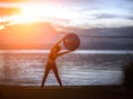 Silhouette yoga ball yung woman in the beach Royalty Free Stock Photo