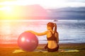 Silhouette yoga ball yung woman in the beach sunset Royalty Free Stock Photo