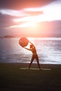 Silhouette yoga ball yung woman in the beach sunset Royalty Free Stock Photo