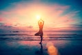 Silhouette yoga girl on the background of stunning sea and sunset.