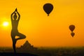 Silhouette yoga pose woman standing on the mountain sunset