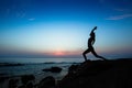 Silhouette of yoga woman doing exercises on the ocean beach Royalty Free Stock Photo