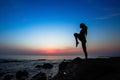 Silhouette of yoga woman doing exercises on the ocean beach Royalty Free Stock Photo