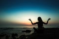 Silhouette of a yoga woman in Lotus position on the shore Royalty Free Stock Photo