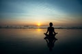 Silhouette yoga woman on the ocean beach at amazing sunset. Royalty Free Stock Photo