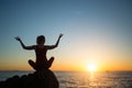 Silhouette of yoga woman practicing during amazing sunset Royalty Free Stock Photo