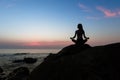 Silhouette of yoga woman sit at Lotus position on the shore of ocean Royalty Free Stock Photo