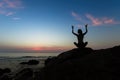 Silhouette of yoga woman sit at Lotus position on the shore of ocean Royalty Free Stock Photo