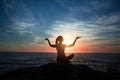 Yoga silhouette woman in meditation on the ocean beach Royalty Free Stock Photo