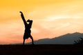 Silhouette of a young acrobatic man standing on hands