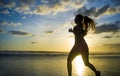 Silhouette of young Asian sport runner woman in running workout Royalty Free Stock Photo