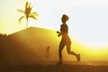 Silhouette of young attractive and fit runner woman with athletic body running on beautiful Summer sunset light training jogging w Royalty Free Stock Photo