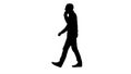 Silhouette Young bearded man walking and talking on the mobile phone. Royalty Free Stock Photo