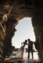 Silhouette of young beautiful bridal couple having fun together at the beach Royalty Free Stock Photo