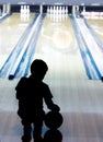 Silhouette of young boy in bowling Royalty Free Stock Photo