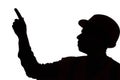 Silhouette of young builder contractor in hard hat on isolated background point with finger, foreman controls work