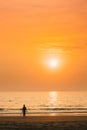 Silhouette Of Young Caucasian Lady Woman In Swimsuit Walking In Sea Beach During Sunset. Vacation On Ocean Beach Royalty Free Stock Photo