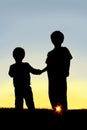 Silhouette Young Children Holding Hands at Sunset Royalty Free Stock Photo