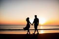 Silhouette of young couple holding hands on the beach at sunset. Ai generated. Royalty Free Stock Photo