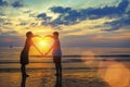 Silhouette of young couple holding hands in heart shape on the ocean beach. Royalty Free Stock Photo